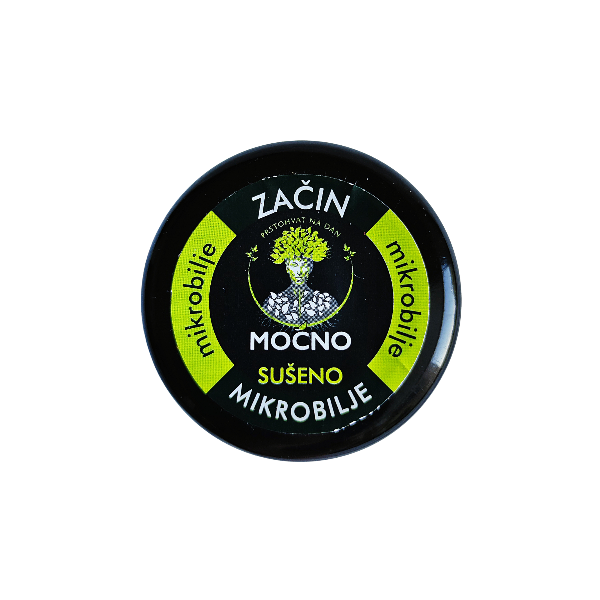 Shot of the jar lid from above. The focus is on the black label with a white circle and the recognizable MOĆNO logo symbolizing the natural power of dried microgreens.