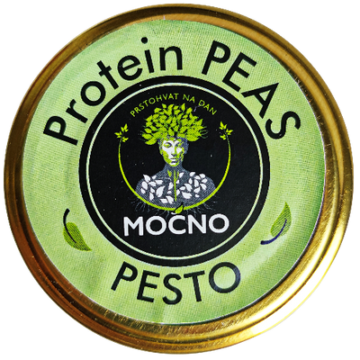 Shot of the jar lid from above. The focus is on the circular light green label with the MOĆNO logo and the name "Protein Peas Pesto", which visually separates this flavor from other spreads in the assortment.